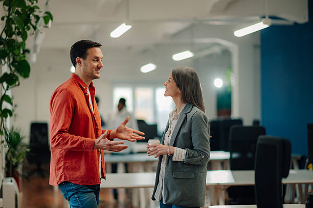 istock Business colleagues engaging in conversation at the office 2204767517