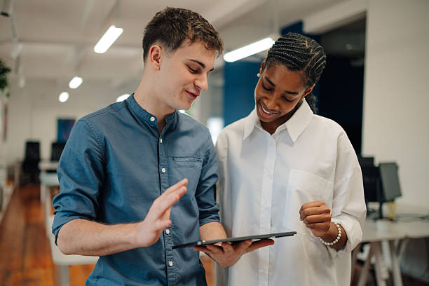 istock Young professionals collaborating on a digital tablet in modern office 2204767635