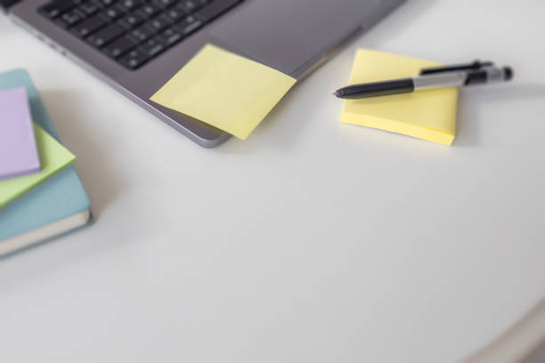 istock A notebook with a blank sheet for notes is glued to a laptop 2204772487