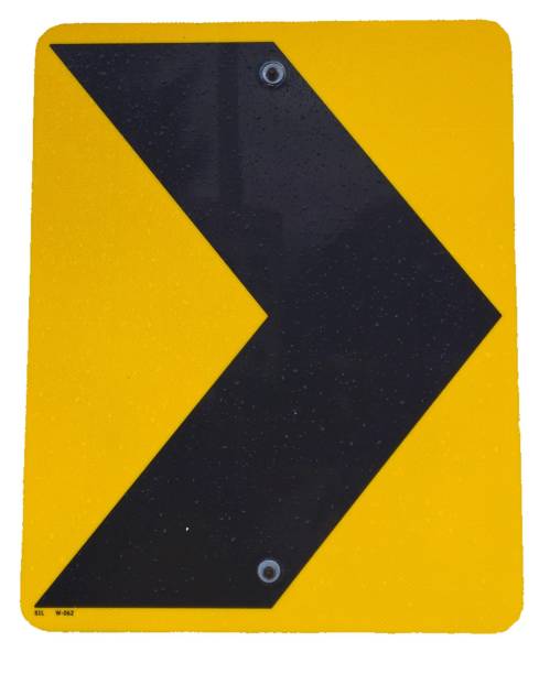Yellow and black chevron sign. A yellow and black chevron traffic sign that points to the right. The sign is yellow and black, with the chevron being black. road chevron warning signs stock pictures, royalty-free photos & images
