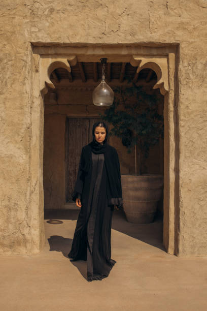 istock Woman in traditional attire walking through an ancient architecture courtyard 2204773388