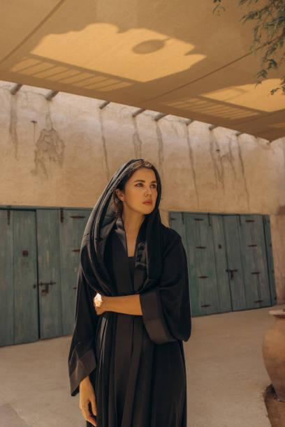 istock Woman Posing Outdoors Wearing Black Robe in Sunny Rustic Setting 2204773455
