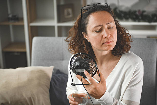 istock woman suffering from heatstroke at home 2204774923