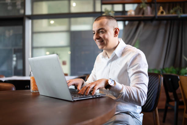 istock Professional Man Working on Laptop in Modern Office Space 2204780022