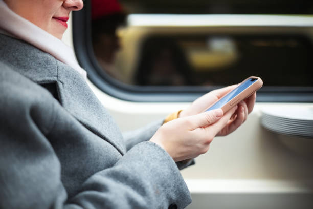 istock Woman Using Smartphone While Traveling on Public Train in Winter Weather 2204781056