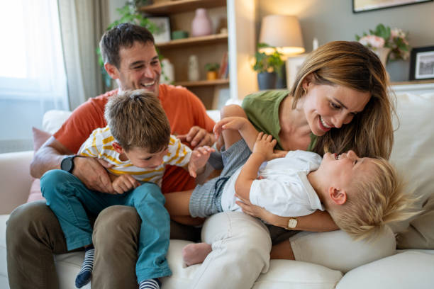 istock Happy family playing together on the sofa at home 2204781925