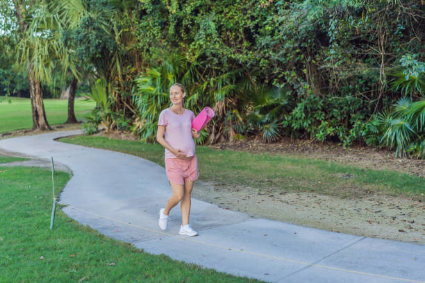 istock Energetic pregnant woman takes her workout outdoors, using an exercise mat for a refreshing and health-conscious outdoor exercise session 2204790336