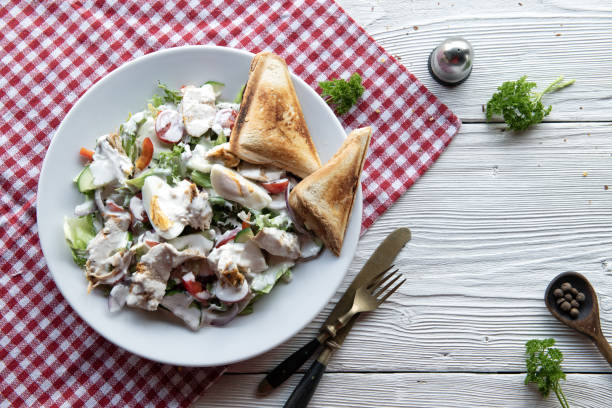 A white bowl full of chicken salad