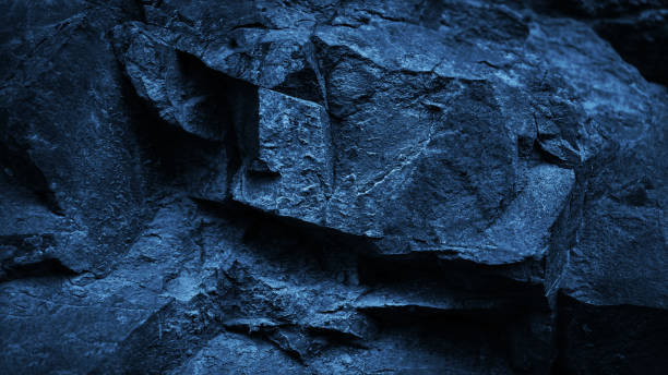 Black dark brown orange rusty beige stone rock granite background. Mountain surface texture. Close-up. For design.