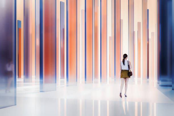 istock Young woman walking in abstract glass environment 2204804336
