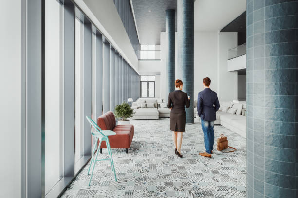 istock Business couple talking in office building lobby 2204804391