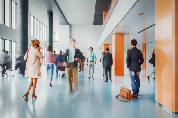 istock Business people walking in office building lobby 2204804400