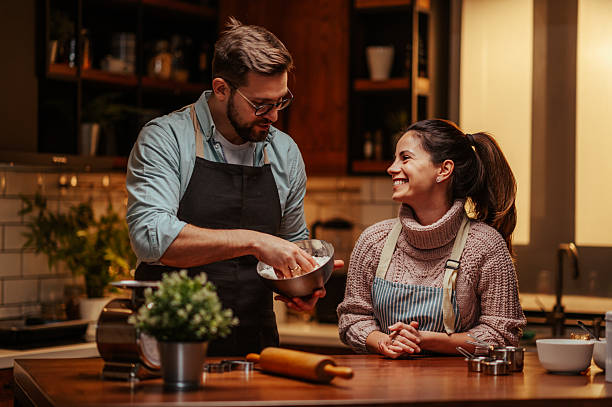istock Couple enjoying cooking together in cozy kitchen 2204807783