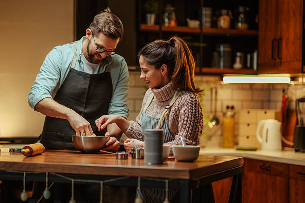 istock Couple enjoying cooking together in cozy kitchen 2204807794