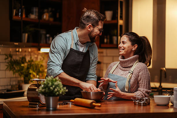 istock Couple enjoying cooking together in modern kitchen 2204807795