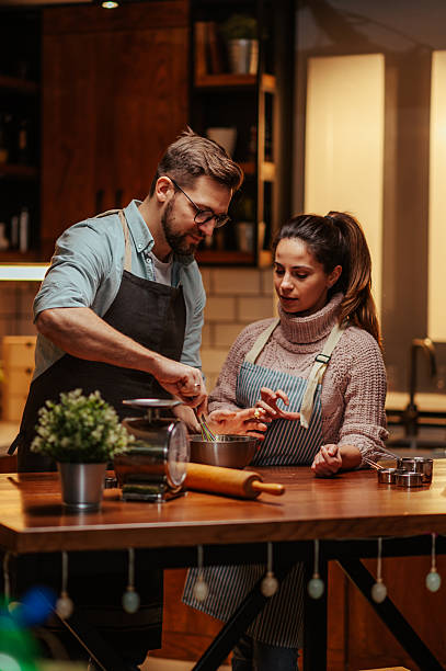 istock Couple enjoying cooking together in cozy kitchen 2204807799