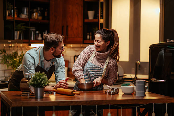 istock Couple enjoying cooking together in cozy kitchen 2204807803
