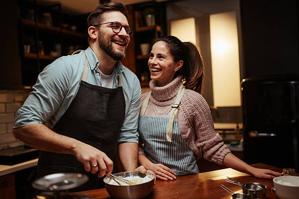 istock Happy couple cooking together in cozy kitchen 2204807828
