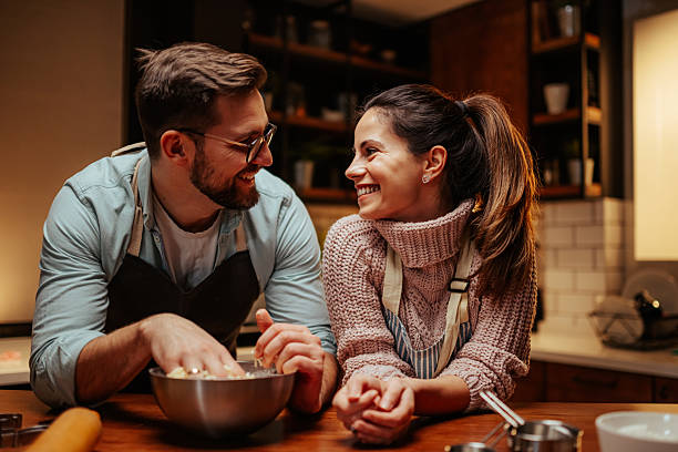 istock Smiling couple enjoying baking together in kitchen 2204807838