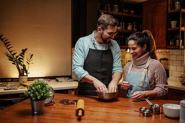 istock Couple enjoying cooking together in cozy kitchen 2204807847
