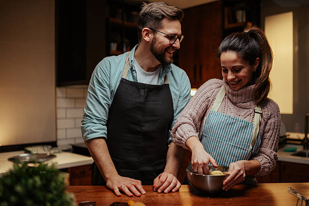 istock Couple enjoying cooking together in cozy kitchen 2204807852