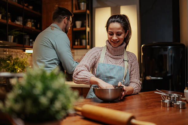 istock Couple enjoying cooking together in modern kitchen 2204807870