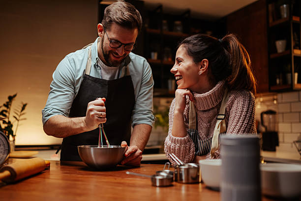 istock Couple enjoying cooking together in modern kitchen 2204807880