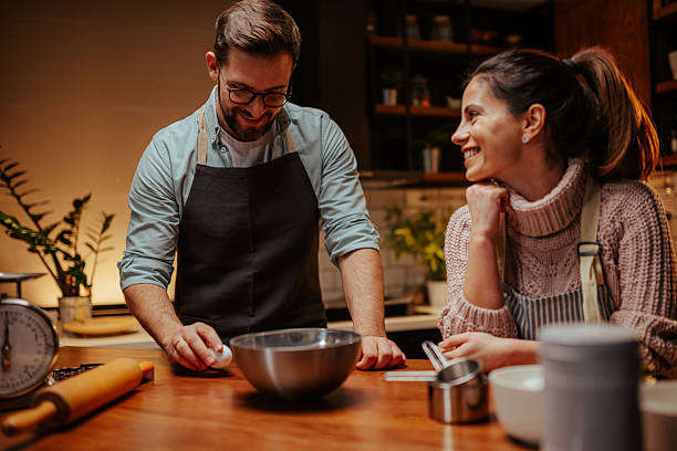 istock Couple enjoying cooking together in modern kitchen 2204807893