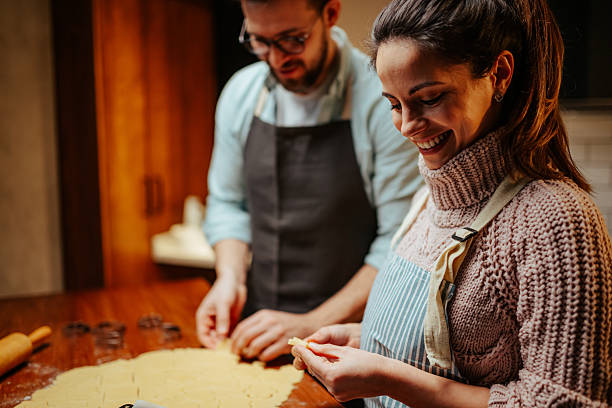 istock Smiling couple enjoying baking together in kitchen 2204807914