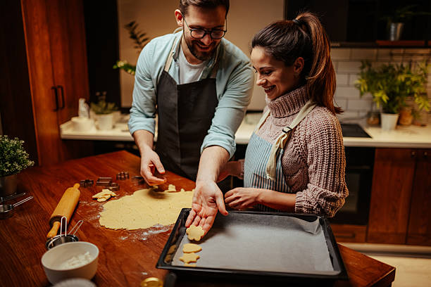 istock Couple enjoying baking cookies together at home 2204807922