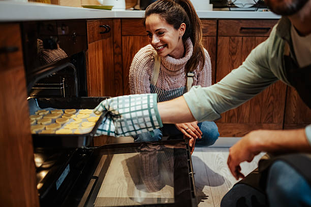 istock Couple baking cookies together in kitchen 2204807932