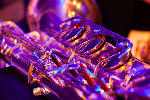 Close-up fragment of saxophone valves in stage light