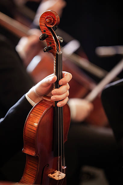 istock Hand of a musician holding a violin 2204810724