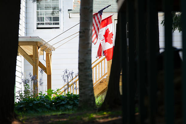 istock Flags of Canada, US, and Ontario fly at a rustic lakeside resort. 2204814741