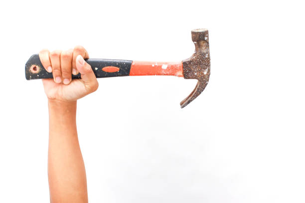 Hand holds a rustic Hammer tool against a clean white background, representing construction.