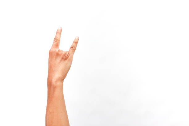Expressive hand gesture against a clean white backdrop, conveying a rock on sign.