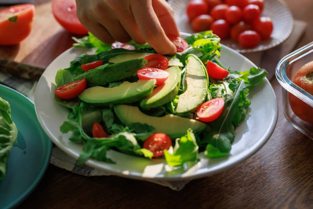 istock Healthy Avocado and Tomato Salad Preparation 2204824575