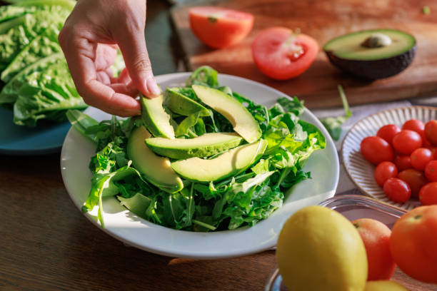 istock Plating Fresh Avocado Salad with Greens 2204825804