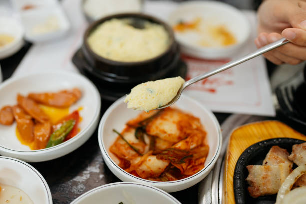 istock Asian woman spoon scooping Korean steamed egg 2204826150