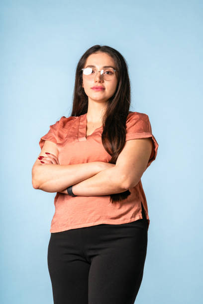 istock Confident Middle Eastern Woman in Satin Blouse Against Light Blue Background 2204829798