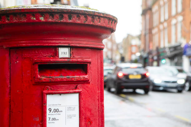 istock Close-up of a red post box with high street traffic 2204829849