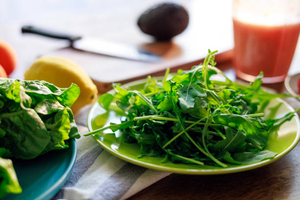 Fresh Arugula and Lettuce on a Plate with Healthy Ingredients in the Background