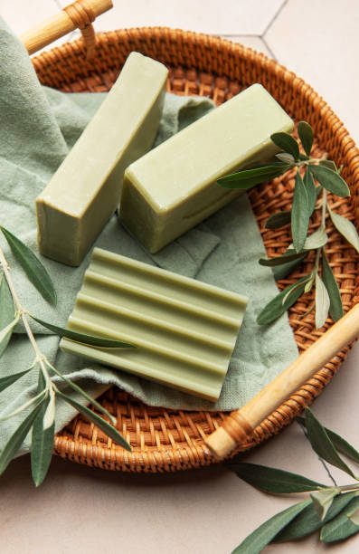 istock Olive soap bars with olive branches resting on a woven tray 2204830913