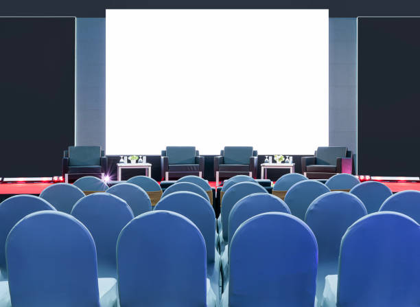 istock Four black armchair for speaker on stage and white screen display backdrop at business presentation exhibition 2204831380