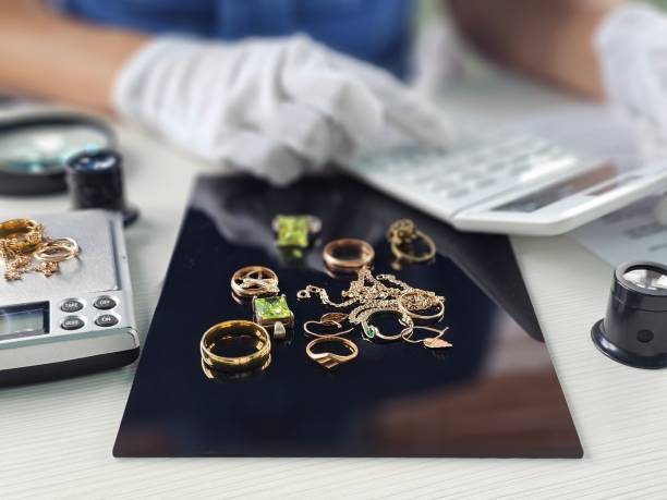 istock Jewelry appraisal process taking place on a table with scales and calculator 2204836892