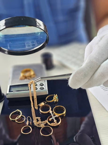 istock Jewelry appraisal process with magnifying glass and scale 2204836893