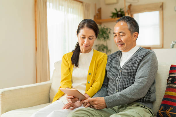 istock An elderly couple using a tablet device in the living room 2204837240