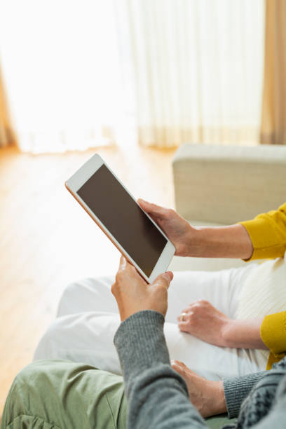 istock An elderly couple using a tablet device in the living room 2204837437