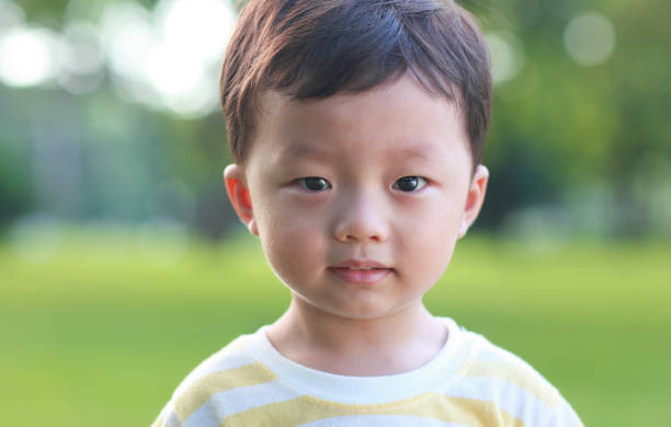 istock Cute children playing in the park 2204837531
