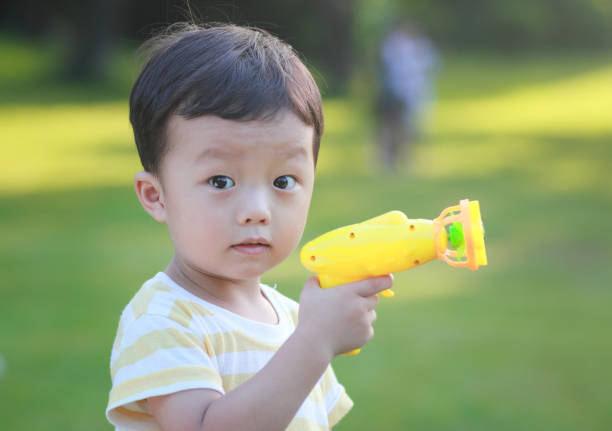 Children with toy guns in the park